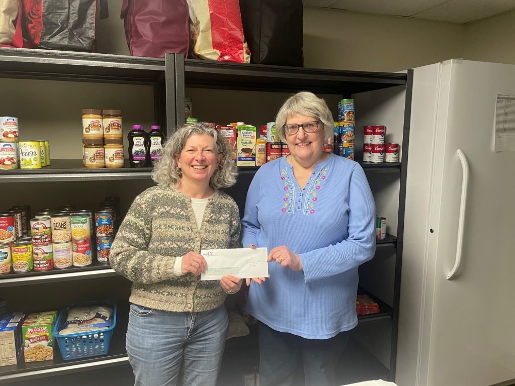 Two woman holding a check donation to the Southampton Community Cupboard.