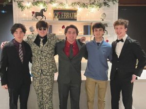 Four highschool students dressed in formal suits and smiling. 