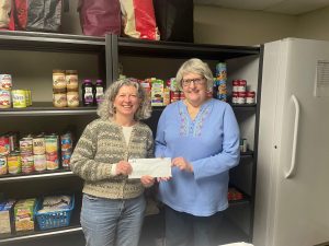 Two women holding a check donation to a local food pantry.