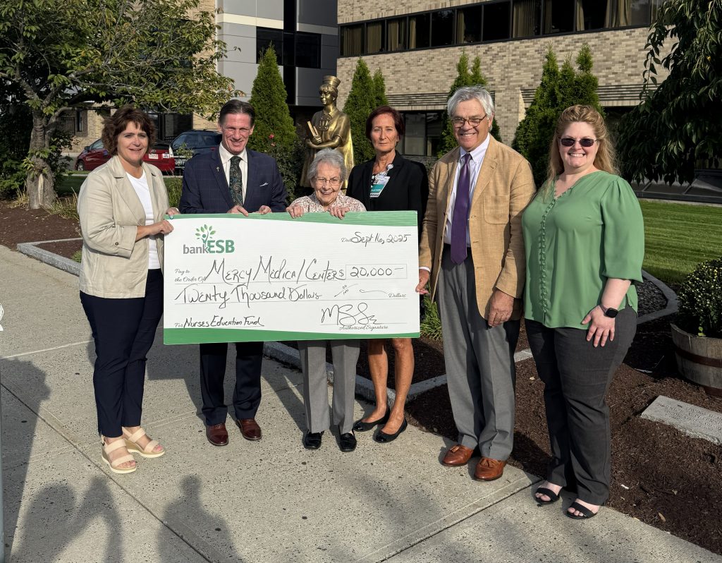 A check donation to Mercy Medical Center.